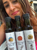 Claudia Hanna-Veysel, founder of Olive Oil Flights, holding bottles of the Egyptian Shemlaly, Morrocan Picholine, and Tunisian Chetoui extra virgin olive oil.